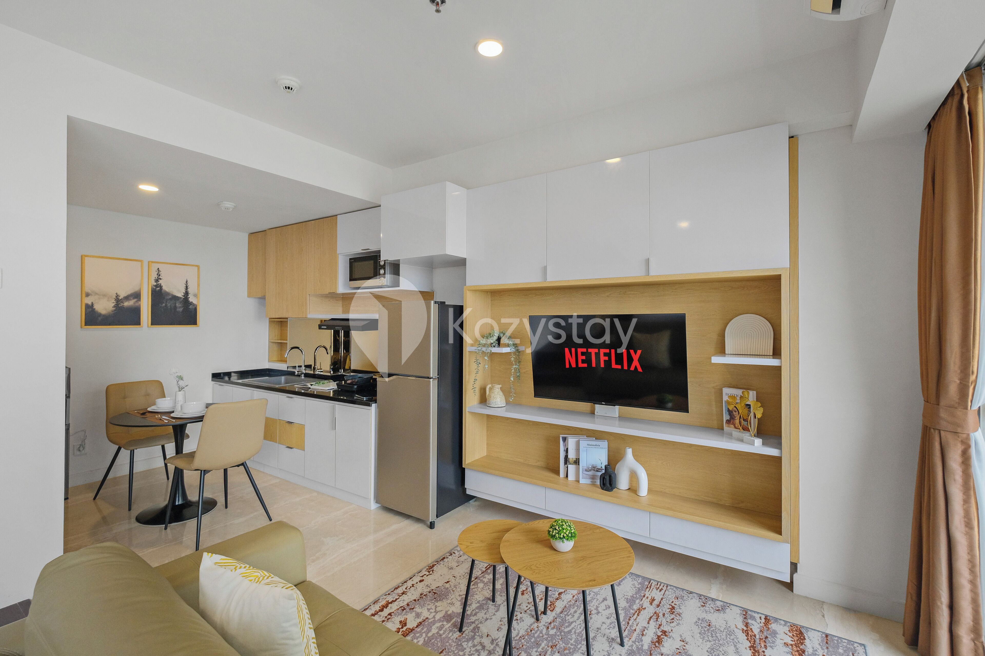 A modern apartment with a kitchen, dining area, and living room.