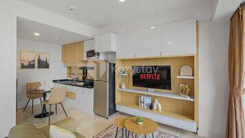 A modern apartment with a kitchen, dining area, and living room.