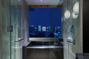 Separate tub and shower, rainfall showerhead, eco-friendly toiletries