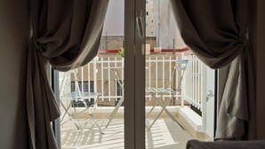 A room with a view of a balcony featuring a white metal chair and a small table. - SILIA Reno Studio Athens Ambelokipi Metro (Athens)