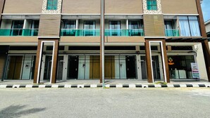 A modern hotel with a symmetrical facade, large glass windows, and a central entrance. - HPY Hotel (Ipoh)