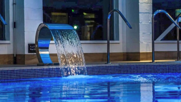 A swimming pool with a water feature, a pool deck, and a sign indicating a pool depth of 1.2 meters. - 2 bedroom accommodation in Patrington Haven (Patrington Haven)