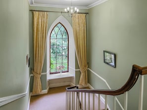 A staircase with a wooden handrail leading to a landing with a window. - Hafod Grove - UKC6955 (Moylegrove, near Ceibwr Bay)