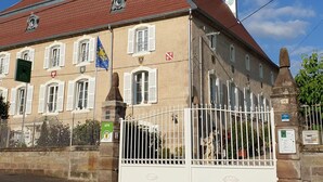 A historic building with a red-tiled roof, white shutters, and a statue in front. - Charming Studio with Garden and Terraces, Peaceful and Historic Setting (Mersuay)