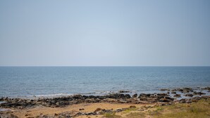 A coastal landscape with a rocky shoreline and calm sea. - Kymè - One Bedroom Apartment, Sleeps 4 (NOTO)