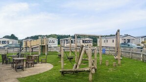 A playground with wooden structures and tables, surrounded by mobile homes. - 3 bedroom accommodation in Tosside, near Settle (Tosside, near Settle)