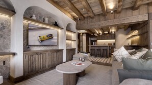 Une cuisine moderne avec des poutres en bois, un coin bar et un espace détente avec une table ronde.