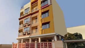 A multi-story building with balconies, air conditioning units, and a gated entrance. - Green Edge Regency (Kolkata)