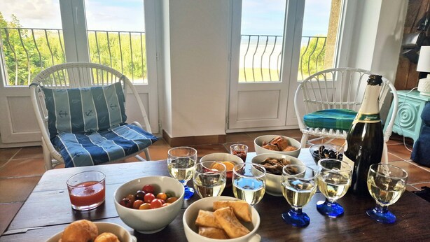 A dining table with various dishes, glasses of wine, and a bottle of champagne. - Ker Aloueder, sleeps 10, beach access, panoramic sea view (Santec)