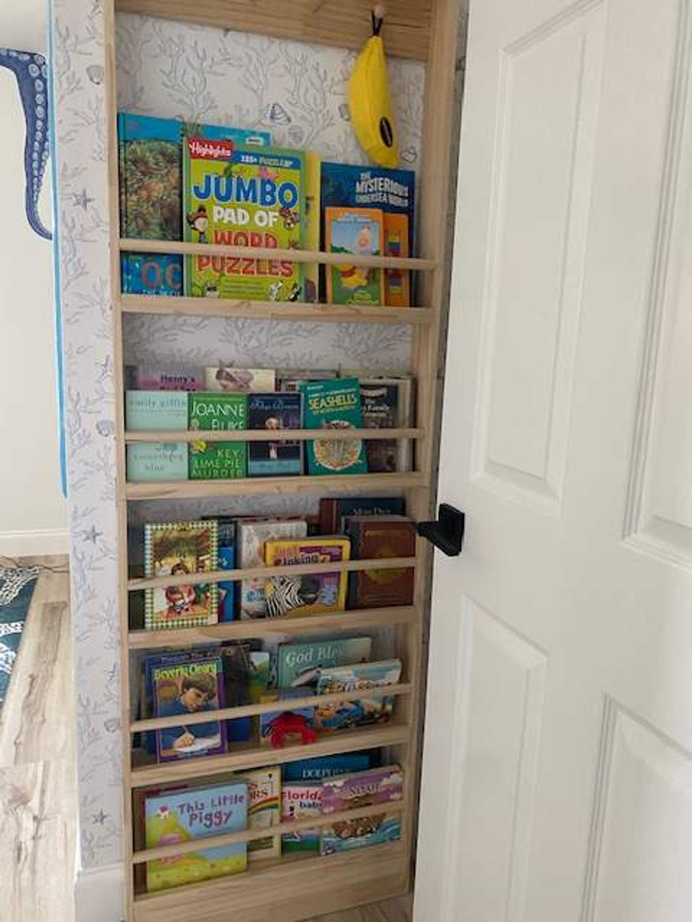 A bookshelf filled with various children's books and puzzles.