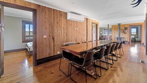 A spacious room with a long wooden table and chairs, a mounted deer head, and a fireplace. - Rustic country lodge with spectacular fire pit and nearby hiking trails (Hallston)