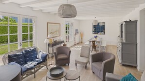 Un vaste espace de vie doté d’un haut plafond, d’une table à manger pour quatre personnes et d’un buffet gris.