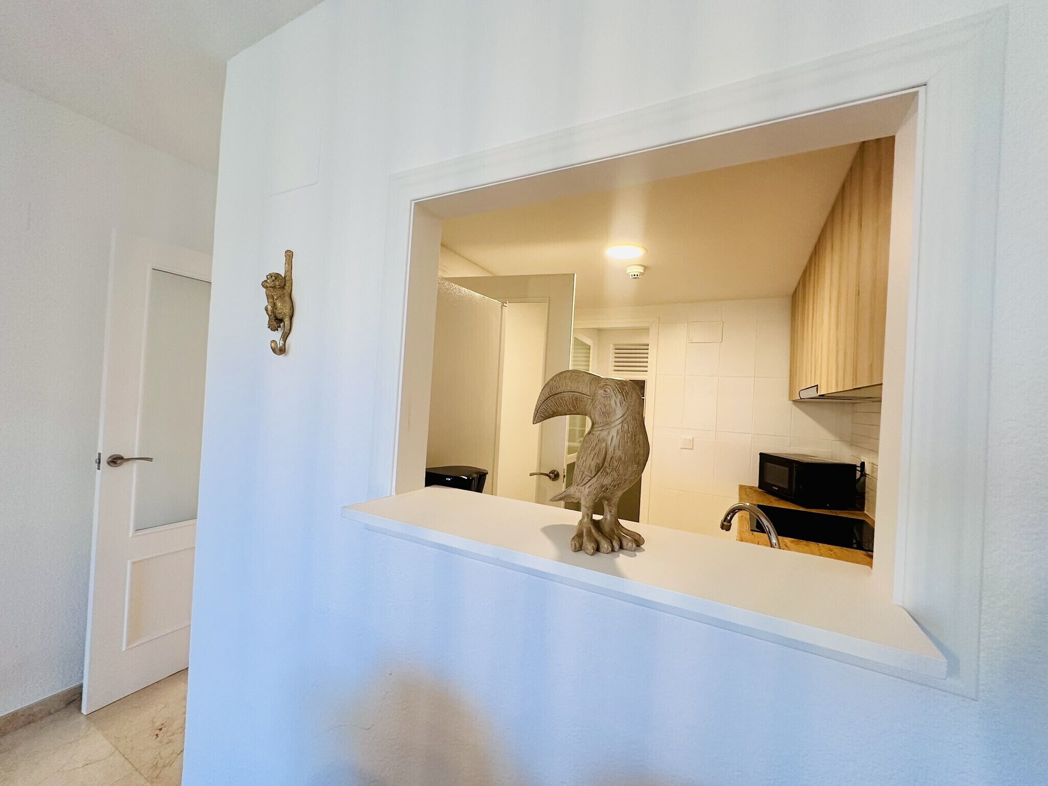 A bathroom with a large mirror, a towel rack, and a toilet.