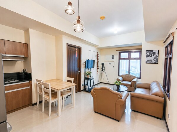 A modern apartment with a kitchen, dining area, and living room.