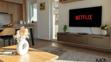 Deluxe Apartment, 1 Bedroom, Balcony, Mountain View | Living area | 125-cm Smart TV with cable channels, Netflix, streaming services