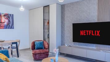 Deluxe Apartment, 1 Bedroom, Balcony, Mountain View | Living area | 125-cm Smart TV with cable channels, Netflix, streaming services