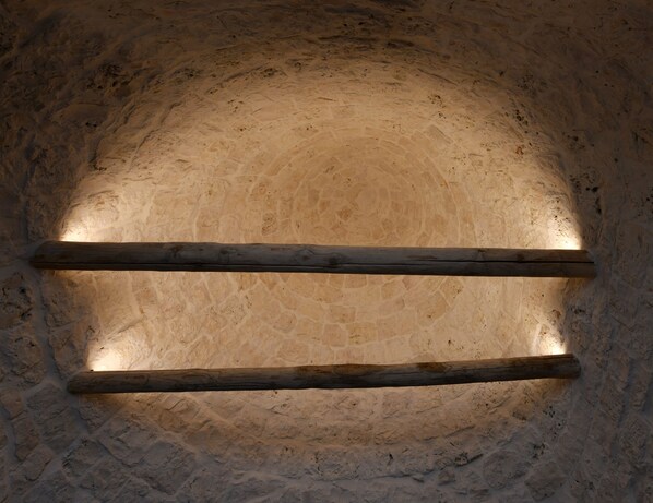 A stone wall with a wooden beam structure.