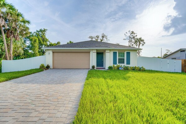 A single-story house with a paved driveway, a garage, and a well-maintained lawn. - 3 Mi to Port Charlotte Beach Park: Home w/ Patio! (Port Charlotte)