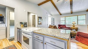 A spacious kitchen with granite countertops, a built-in oven, and a large island. - 4 Mi to Dtwn: Cozy Family Condo in Ruidoso! (Ruidoso)