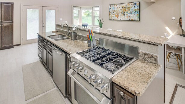 A modern kitchen with granite countertops, stainless steel appliances, and a large island. - Spacious Home w/ Game Room, 2 Mi to Concord Mills! (Concord)