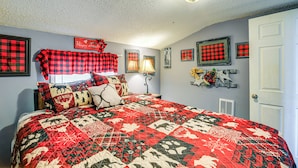 A bedroom with a large bed, a nightstand, a lamp, and a door. - 1 Mi to Hatfield-mccoy Trails: Apt in Matewan (North Matewan)