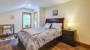 A bedroom with a bed, bedside table, and a desk with a chair. - Mountain & Sunset Views: Upstate Family Home (Granville)