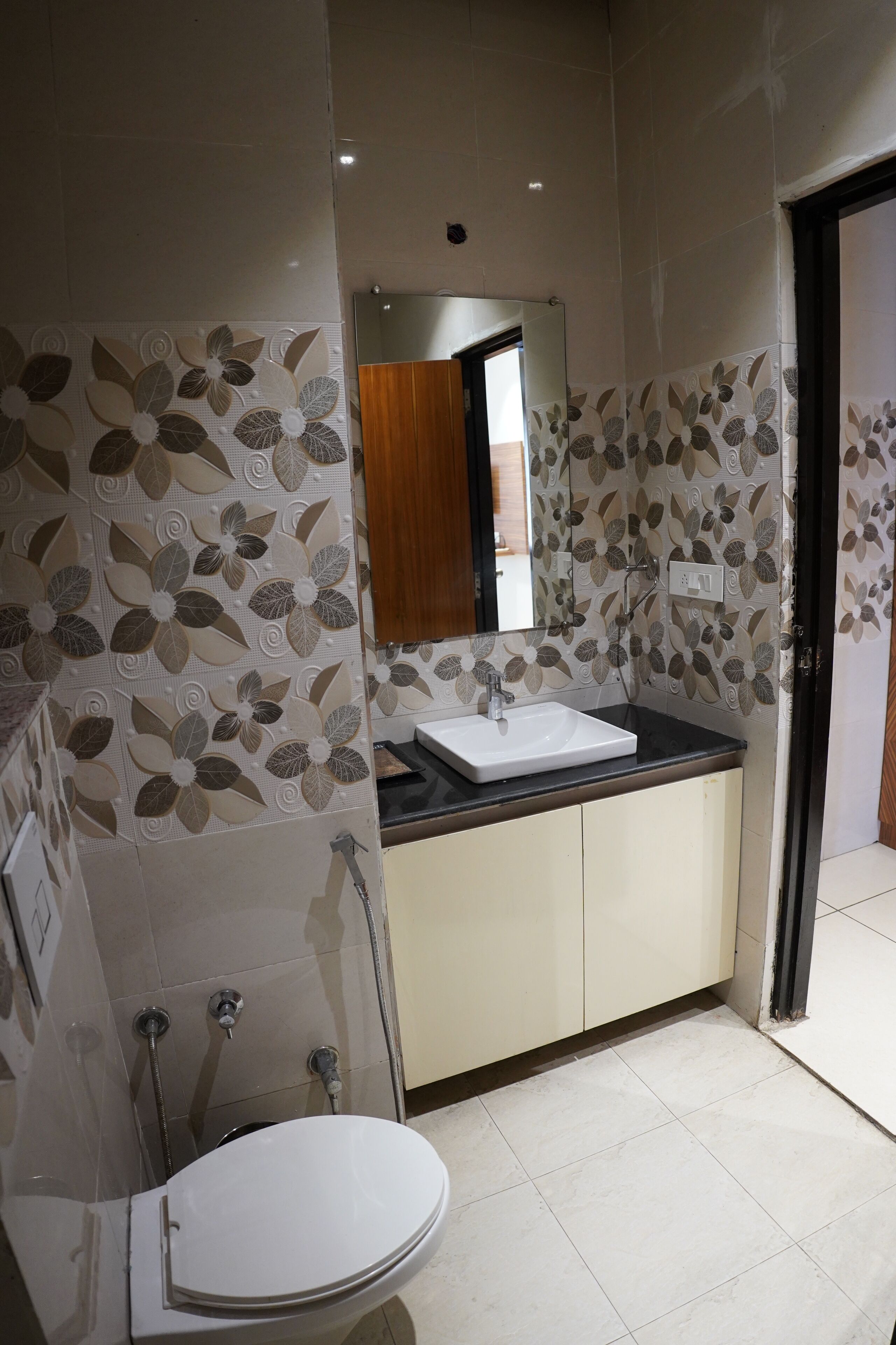A bathroom with a white sink, a mirror, and a toilet.