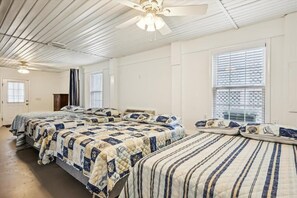 A room with three beds, a ceiling fan, and a window with blinds. - 6br sleeps 24 w/pool & hot tub, golfcart (North Myrtle Beach)