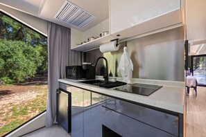 Fridge, microwave, coffee/tea maker, cookware/dishes/utensils