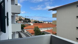 A view of buildings with red-tiled roofs and a clear sky.