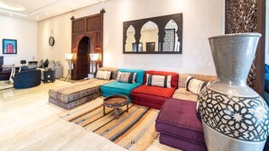 A modern living room with a sofa set, a coffee table, and a decorative vase. - Luxury stay near Marrakech with mountain views, pool, and family fun (Marrakesh)