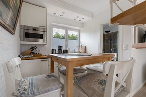 Fridge, stovetop, dishwasher, coffee/tea maker