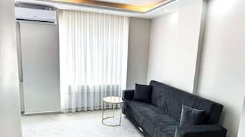 Deluxe Studio, 1 Queen Bed, Balcony | Living area | 82-cm Smart TV with satellite channels, heated floors