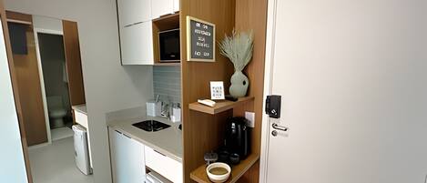 Fridge, microwave, coffee/tea maker, cookware/dishes/utensils