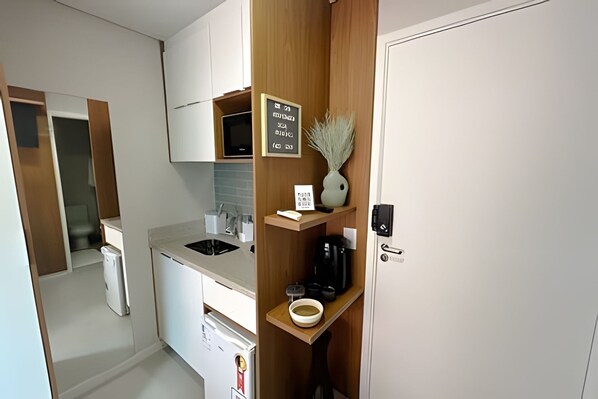 Fridge, microwave, coffee/tea maker, cookware/dishes/utensils