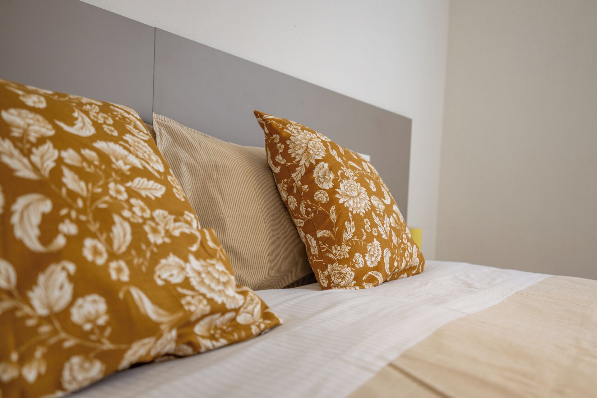 A bed with two pillows and a plain headboard.