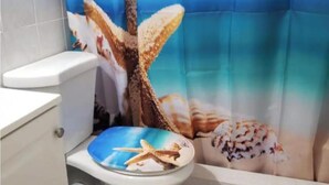 A bathroom with a sea-themed shower curtain featuring starfish and shells. - Affordable private bedroom with private bath with WiFi, AC in Miami B4 (Miami)
