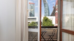 A balcony with a view of modern buildings, including a curved skyscraper. - Large two-room apartment City Life - Mirable PM (Milano)