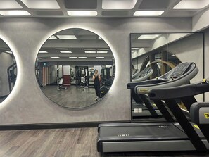 A gym with a large mirror, treadmills, and exercise equipment. - Hillside risedence Phu Quoc (Phu Quoc)