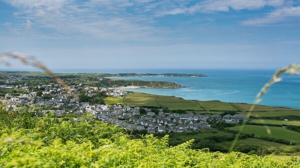 A coastal town with houses, a church, and a view of the sea.