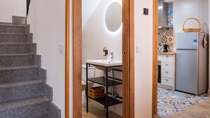 Una cocina con refrigerador, pileta y estufa.