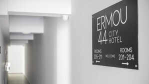 A sign for Ermou 44 City Hotel indicating room numbers 205-211 and 201-204. - Ermou 44 City Hotel (Faliraki)