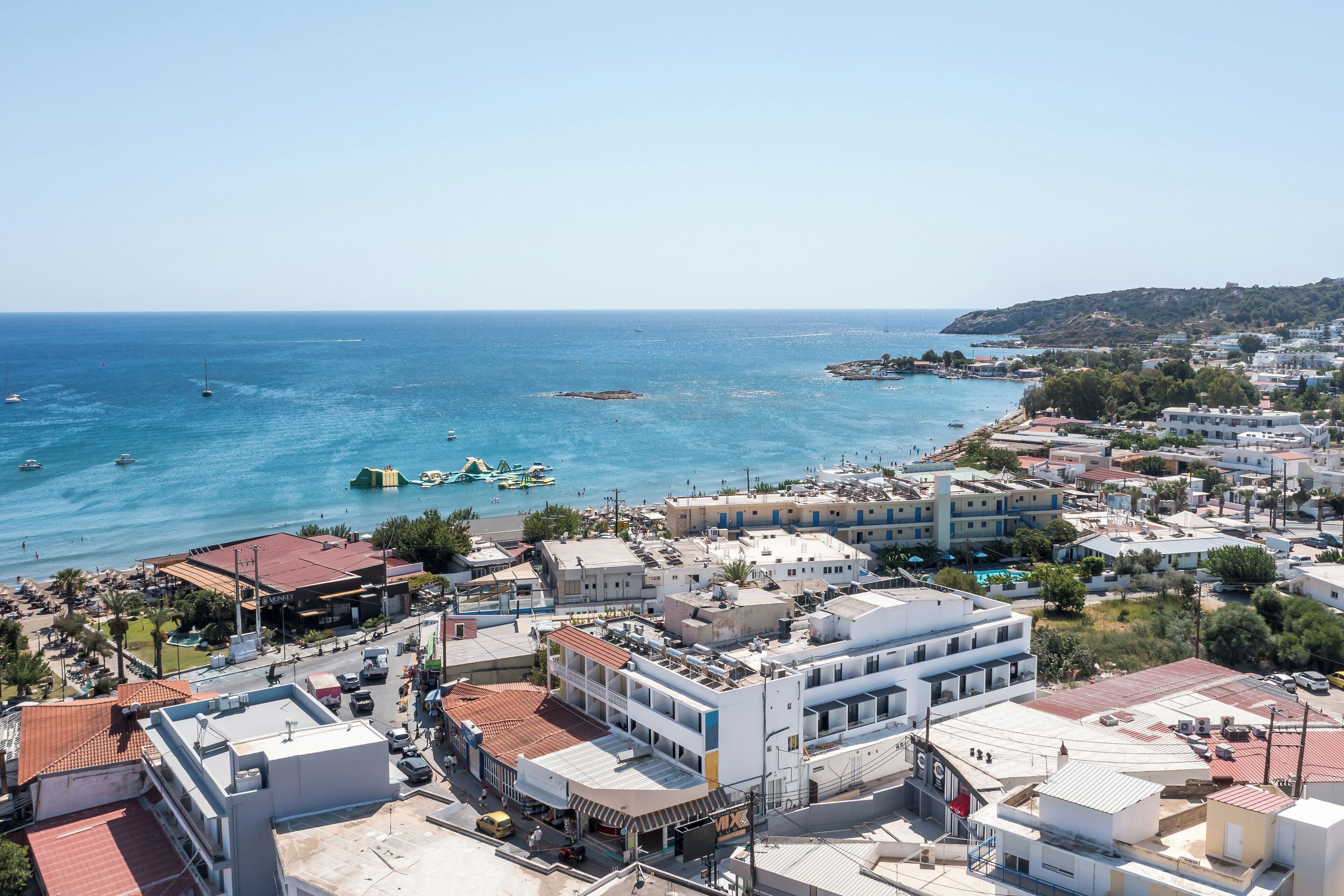 A coastal town with buildings, a marina, and boats.