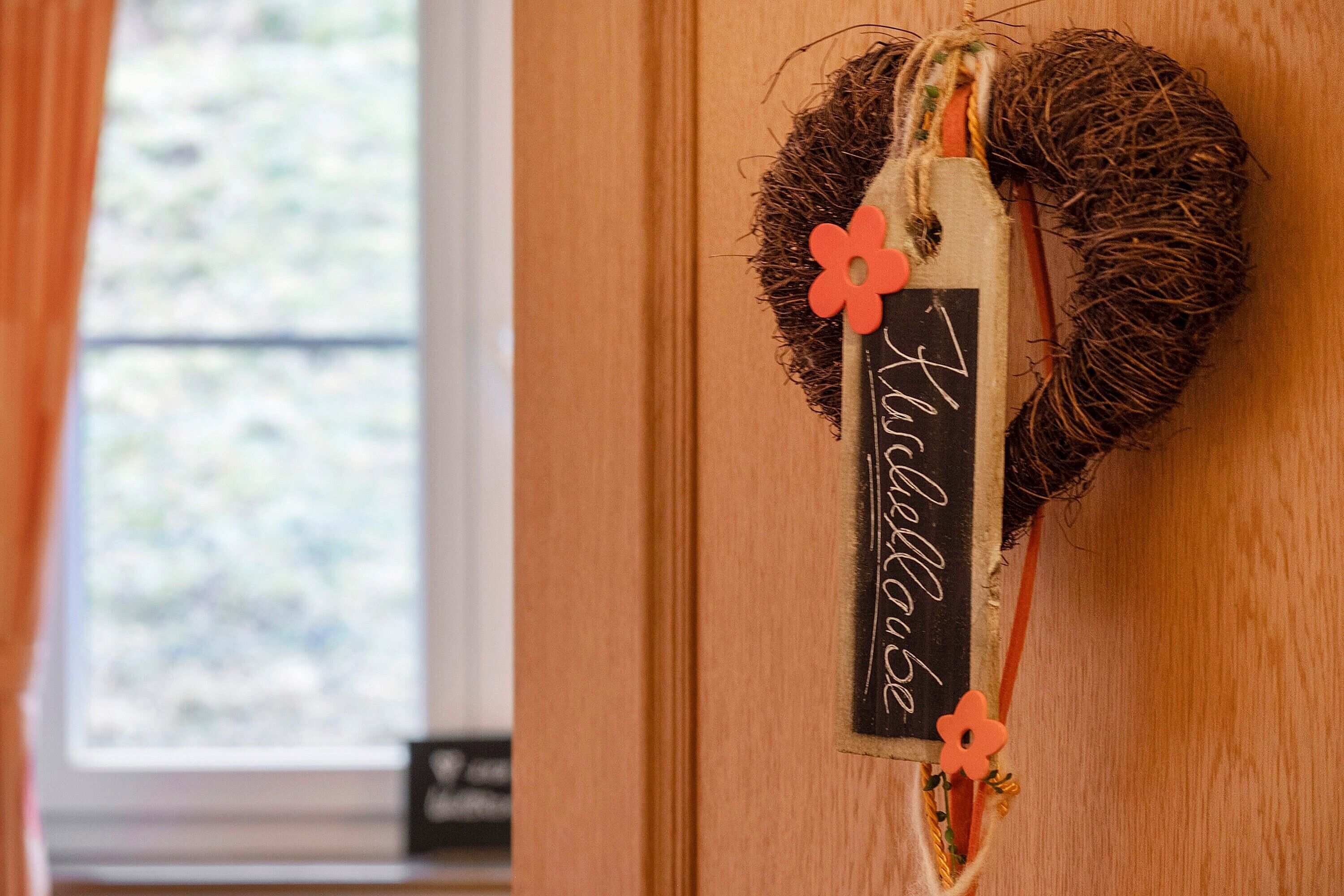 A wooden door with a wreath hanging on it.