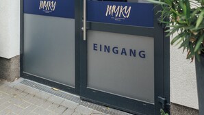 Entrada de un hotel con un letrero que dice "MYKY HOTEL BOARDINGHOUSE HAMBURG" y "Stader Straße 246".