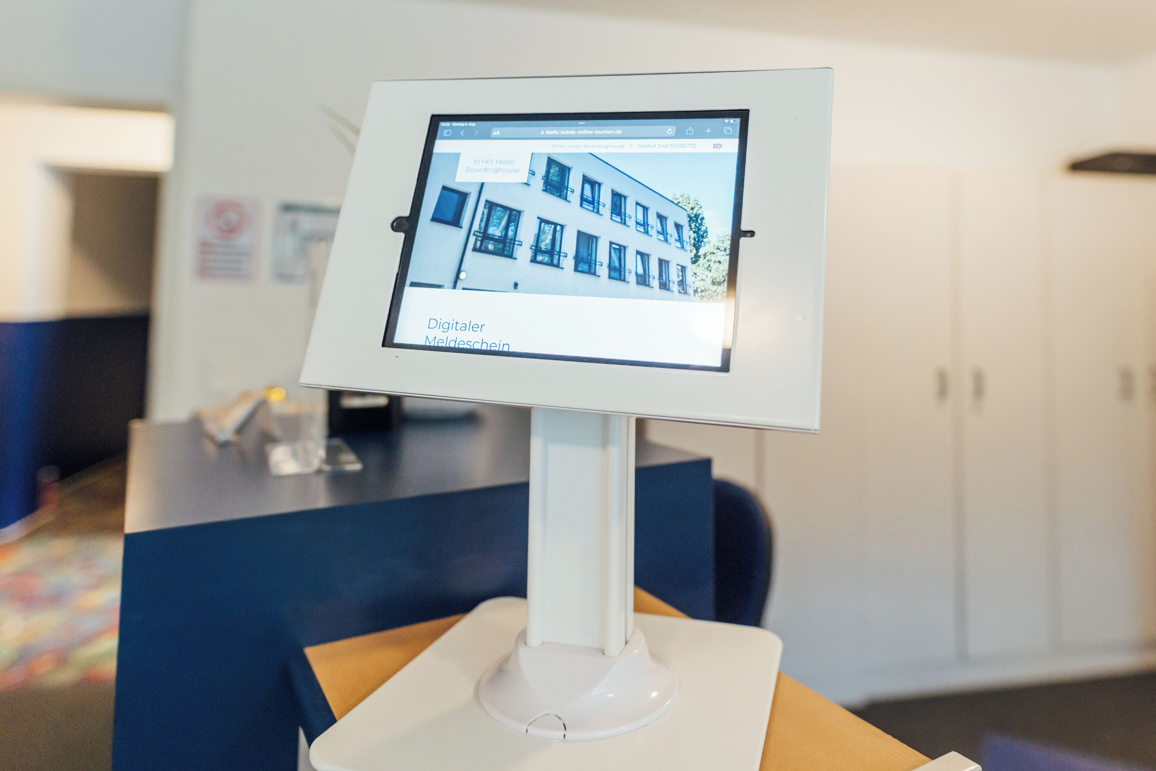 A digital display with a hotel image and the name 'MYKY Hotel Boardinghouse' on it.