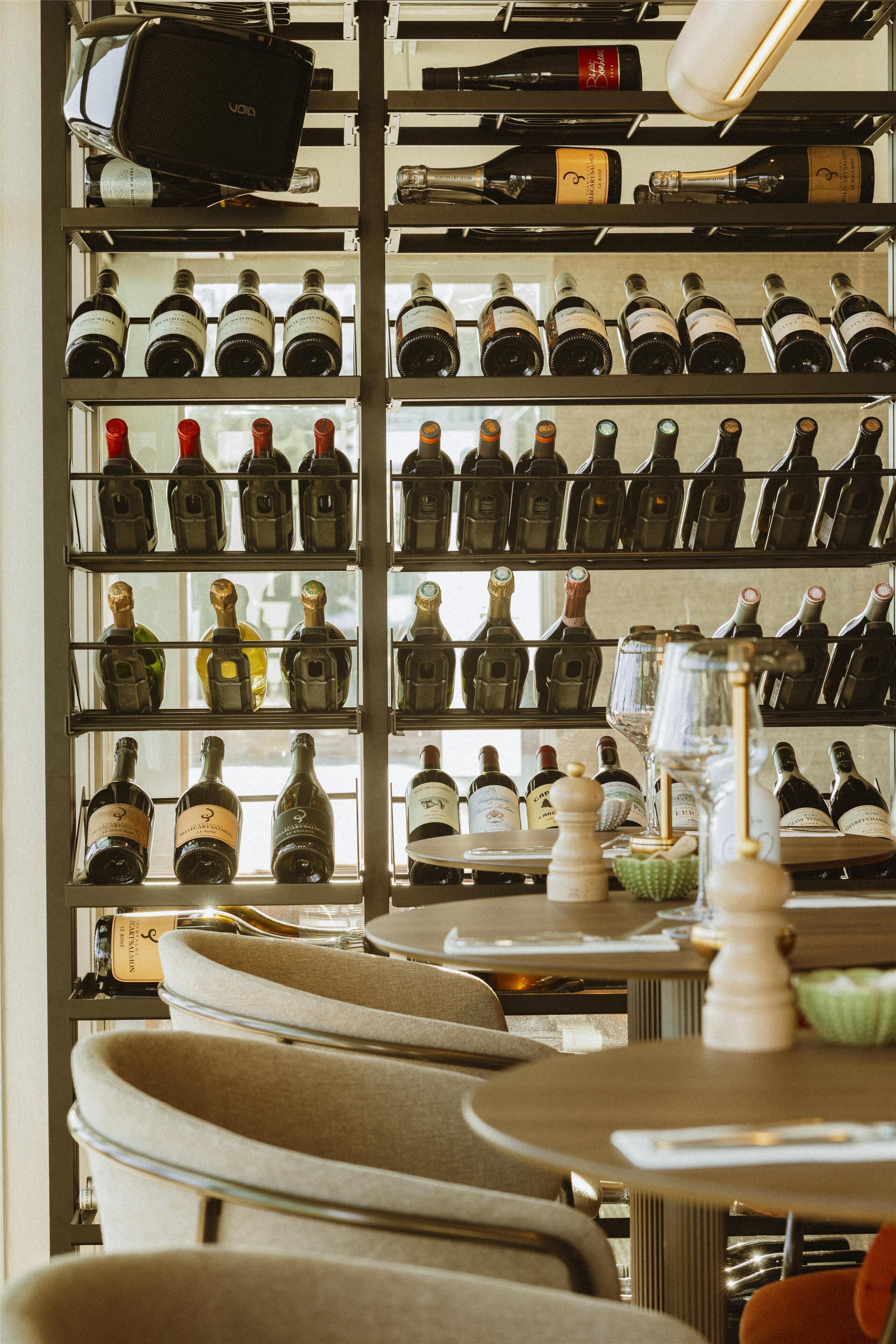 A wine cellar with multiple shelves of wine bottles.