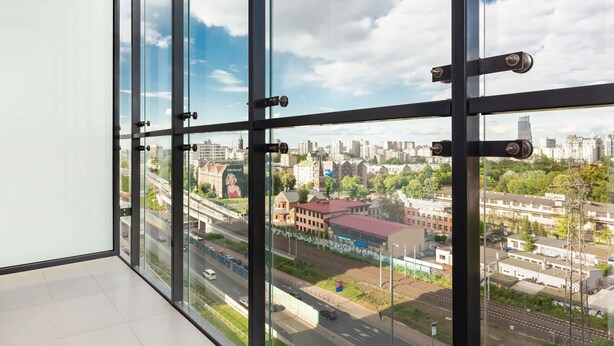 A high-rise room with large windows offering a city view.