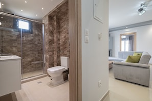 A modern bathroom with a glass shower enclosure, a toilet, and a sink. - Mpia House by Rentalspro (Nea Propontida)