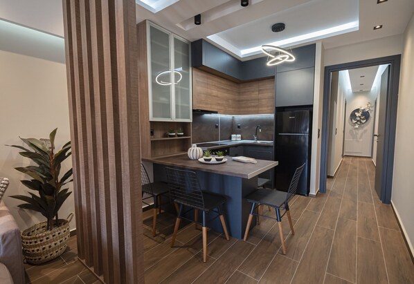 A modern kitchen with a central island, built-in appliances, and a skylight.